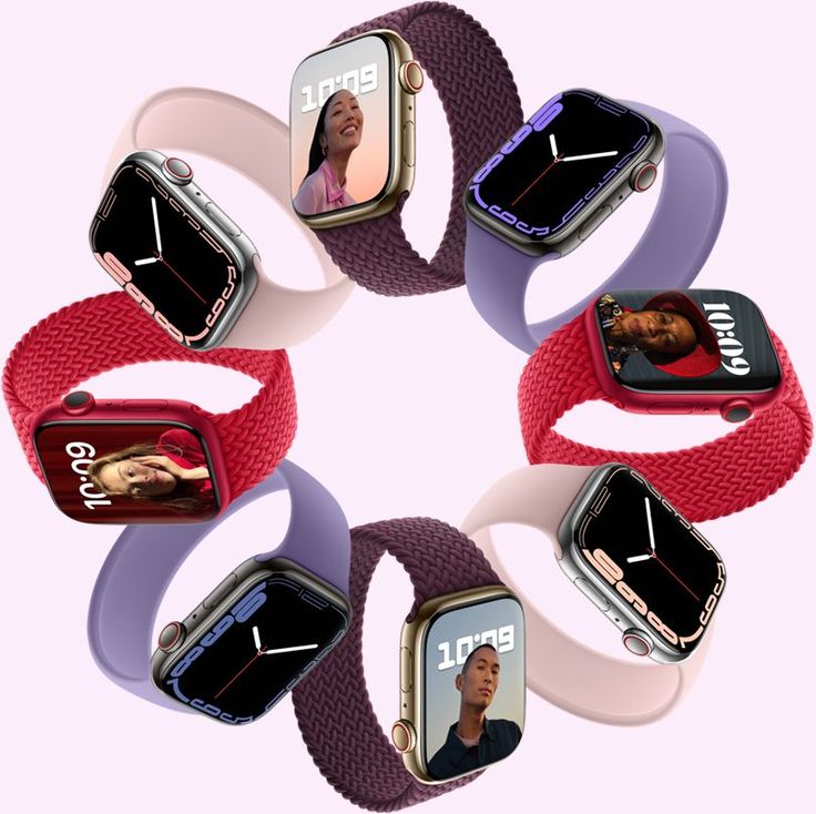 Smartwatches with different colored bands on a light pink background